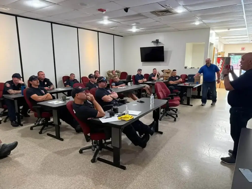Firefighters learning about fire sprinkler systems during Local 669 training.